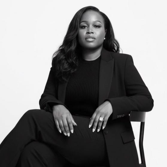 Dr. Gbemisola Adetayo seated in a black suit